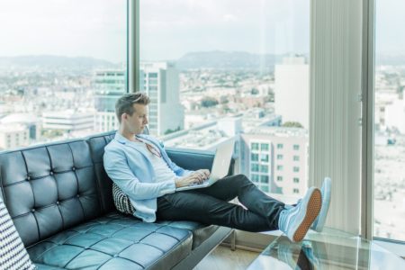 passive income for designers - designer sitting on couch in city