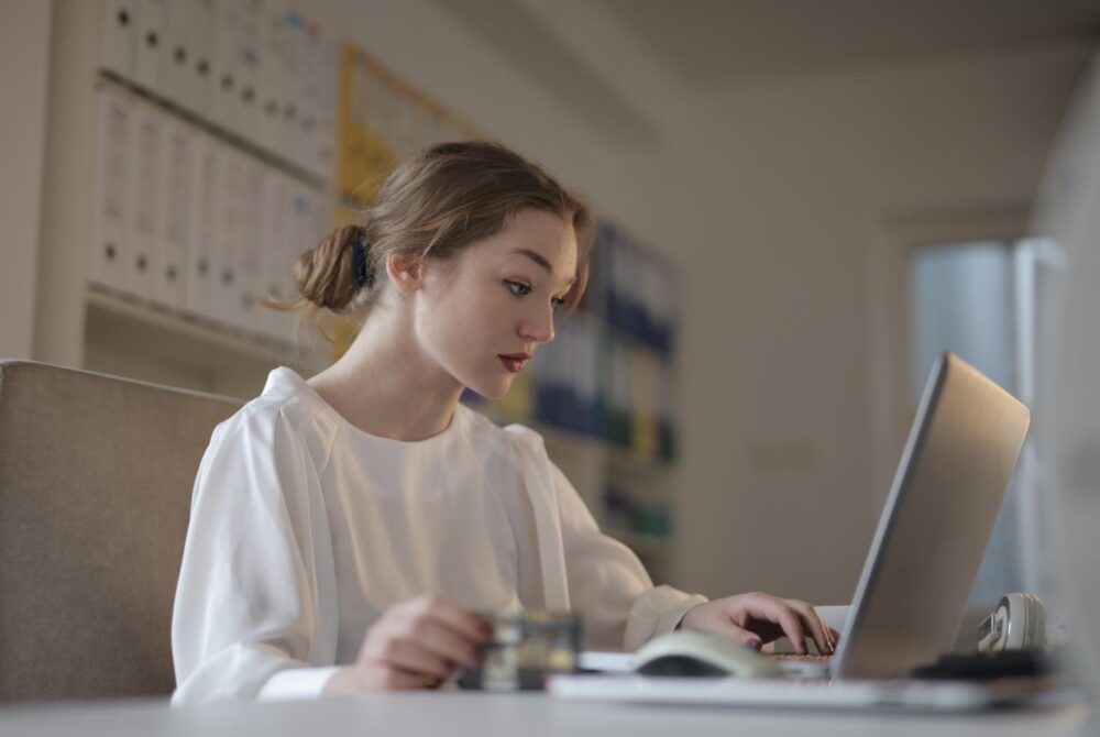 Woman staring intensely at a laptop