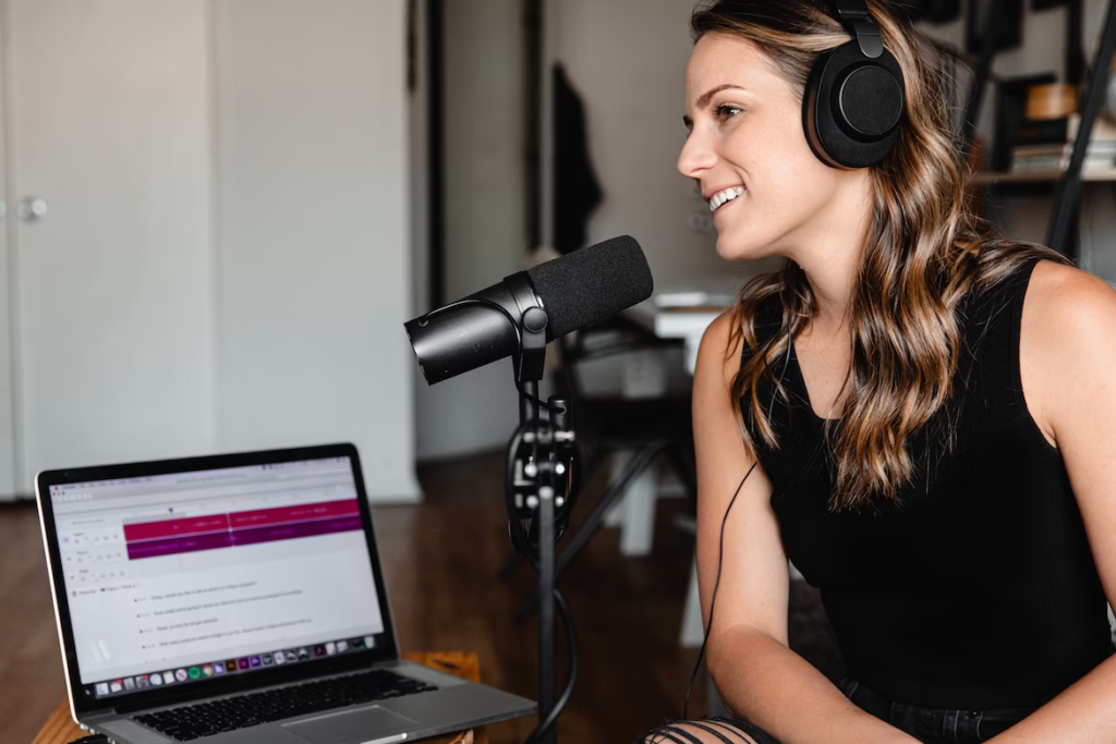 a woman recording an entertaining podcast