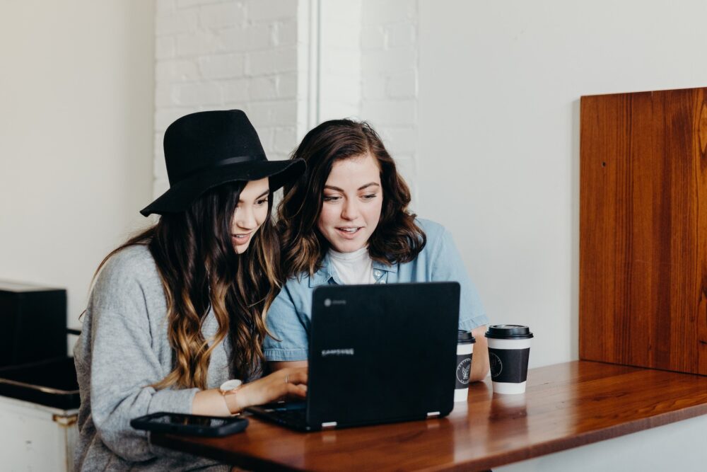 Two Girls Reading Small Business Blogs e1689976842332